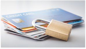 A padlock in front of credit cards.