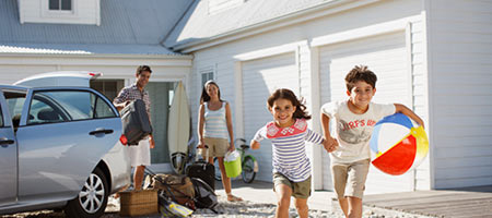 A family arriving at a vacation home, beachside.