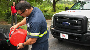 a roadside assistance driver from AAA putting gas into a members car