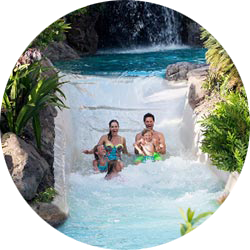 A family of 4 enjoying the rapids of a lazy river.