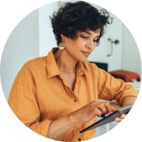 A woman on her using a tablet to check her online savings account