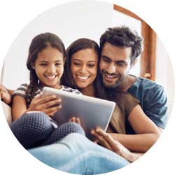 A family of three looking at a tablet screen.