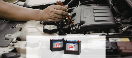 Road Trip Ready. An image of AAA batteries over a car battery installation