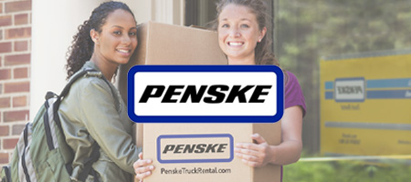 Two women moving Penske boxes.